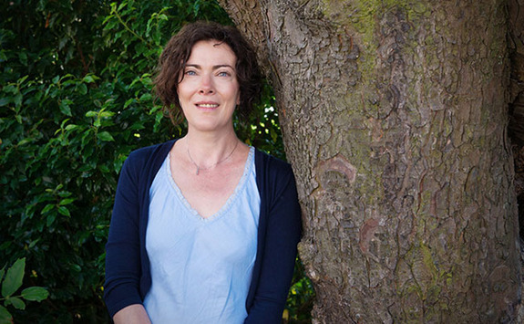 Professor Sally Shortall leaning against a tree